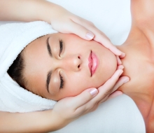 Beautiful young woman receiving facial massage.