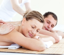 Affectionate couple having a back massage with closed eyes